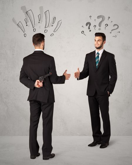 Ruthless businessman handshake with drawn exclamation and question marks around them head