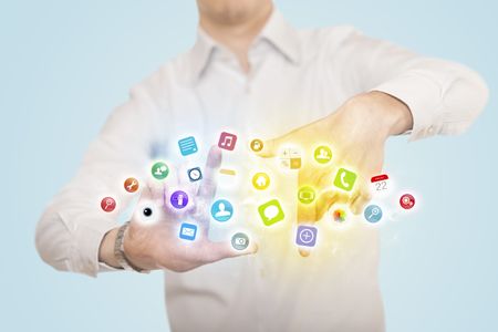 Hands creating a form with colorful mobile app icons in the center
