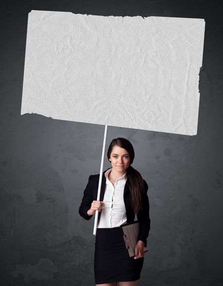 Young businesswoman holding a big blank booklet paper