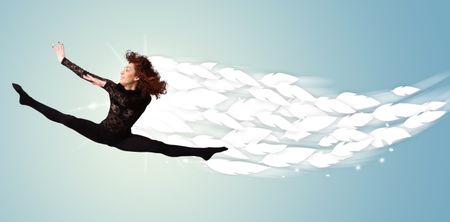 Healthy young woman jumping with feathers around her concept on bright background