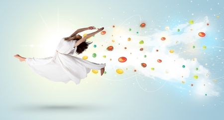 Beautiful woman jumping with colorful gems and crystals on the background concept