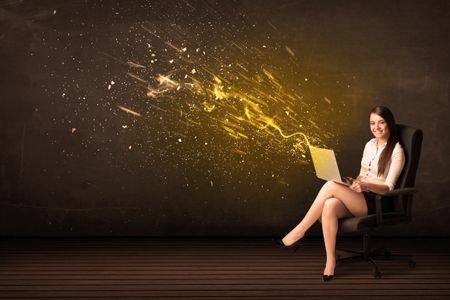 Businesswoman with laptop and energy explosion on background concept