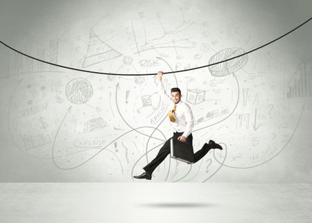 Businessman hanging on a rope with analysis and graphs background