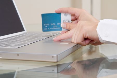 Close up of a woman ordering online with credit card.