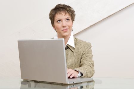Businesswoman thinking while working at computer.