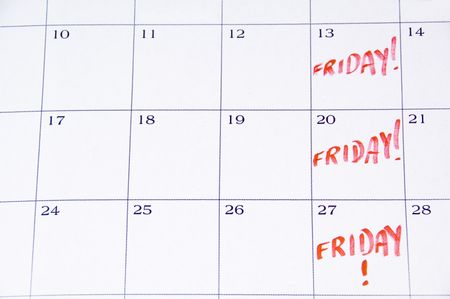 Close-up of white monthly calendar with FRIDAY! written in red