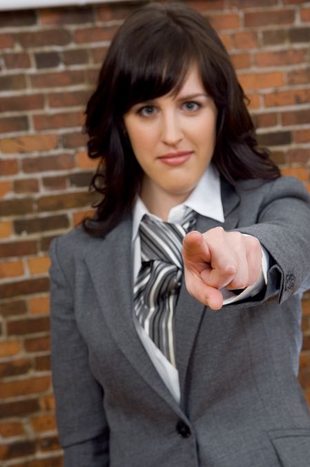 Businesswoman pointing at you.