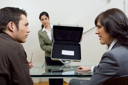 Business team looking concerned at open briefcase.