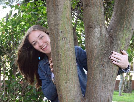 beautiful female behind a tree