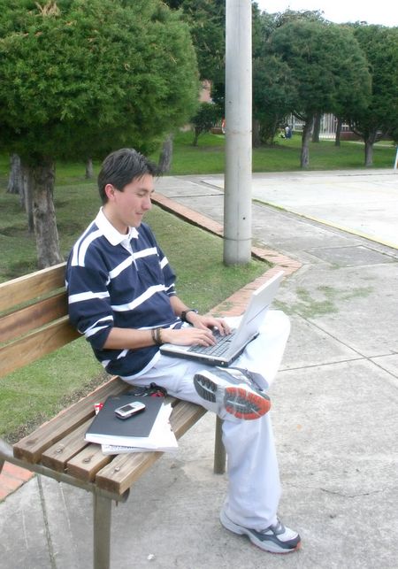 casual guy working on a laptop in the park