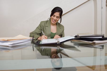 Businesswoman working at desk.