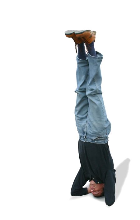 casual male doing the headstand