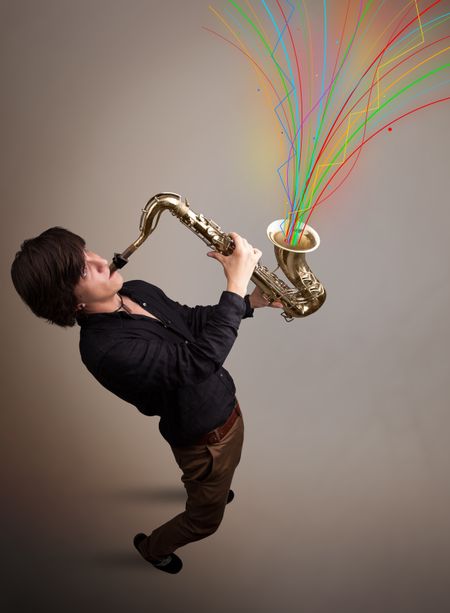 Attractive young musician playing on saxophone while colorful abstract lines exploding