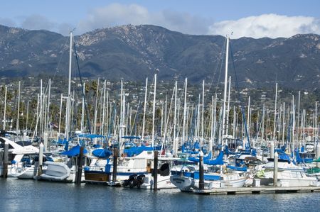 Many yachts in marina, city and mountains beyond, Santa Barbara, California