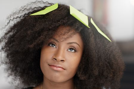 Portrait of a smiling business woman with an afro in bright glass office