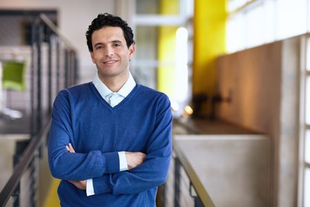 Portrait of a confident businessman at work in his glass office