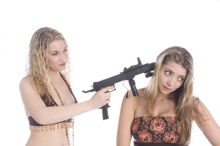 Pretty young blonde holds toy gun to head of sexy friend, isolated on white background
