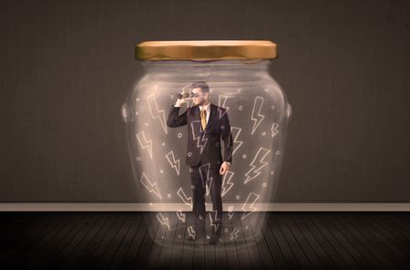 Businessman inside a glass jar with lightning drawings concept on background