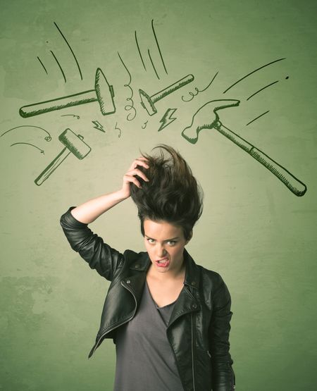 Tired woman with hair style and headache hammer symbols concept on background