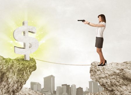 Businesswoman standing on the edge of mountain with a shining dollar mark on the other side 