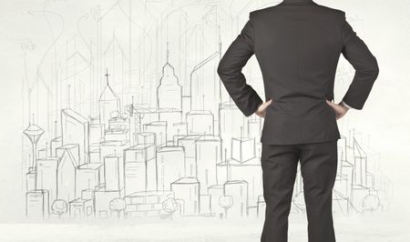 Businessman from the back in front of a drawn city view