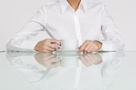Close up of businesswoman's hands with a cup of coffee.