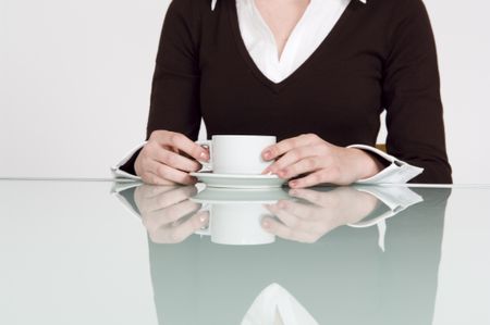 Close up of businesswoman's hands and coffee cup.