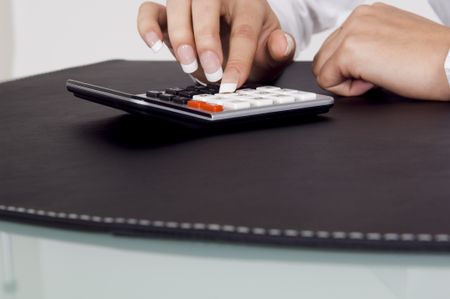 Close up of a calculator being used.