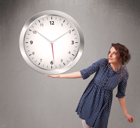Attractive young lady holding a huge clock