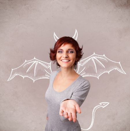 Young nasty girl with devil horns and wings drawing