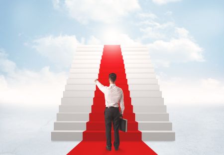Businessman looking at stairs to heaven