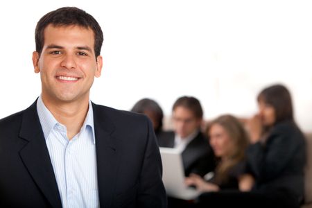 Smiley business man with a group behind him