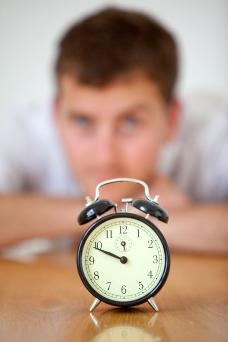 Business man staring at a clock - Time concepts