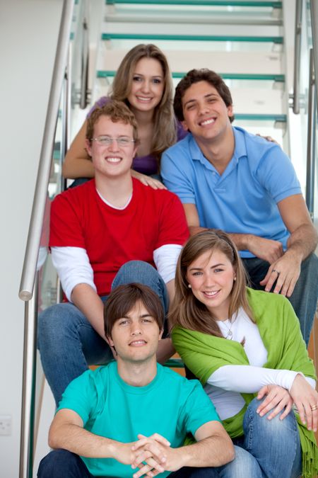 Casual group of friends sitting on the stairs smiling