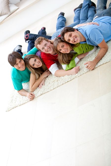 Happy group of friends with their heads together on the floor