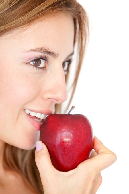 casual woman eating a red apple isolated