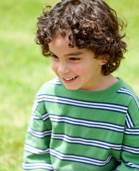 cute little boy portrait standing outdoors smiling
