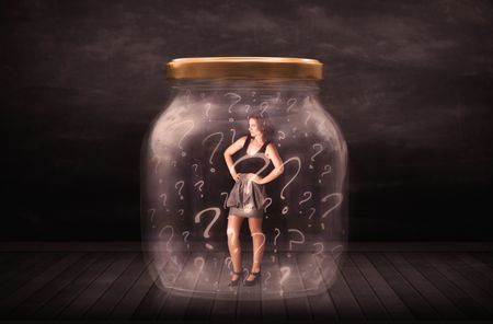 Businesswoman locked into a jar with question marks concept on background