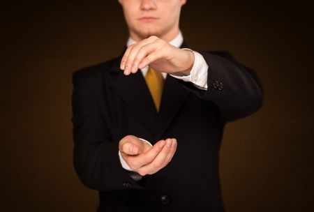 Businessman holding something in front of his body
