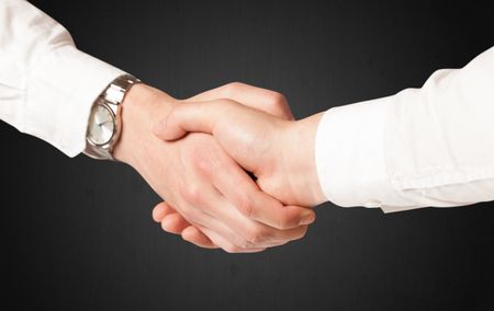 Business handshake on black background