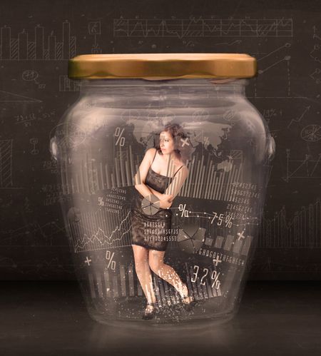 Businesswoman traped in jar with graph chart symbols concept on background