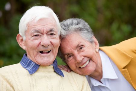 Portrait of a couple of elders smiling outdoors