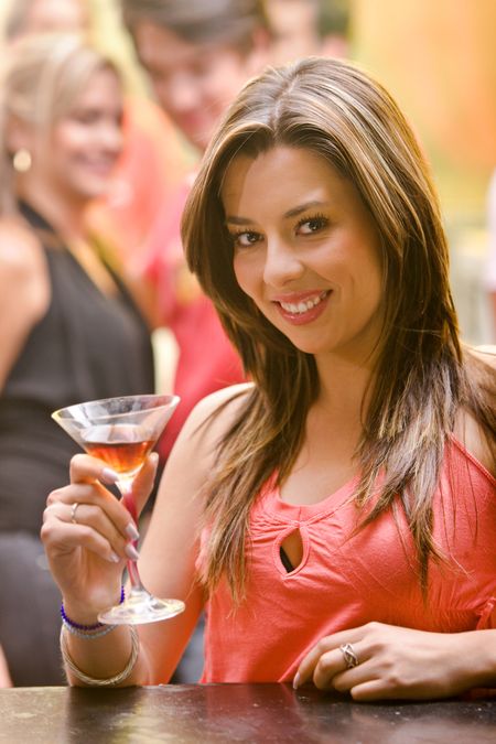 Happy woman smiling in a bar or a nightclub
