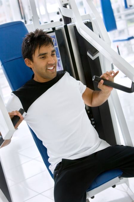 Man at the gym exercising on a machine