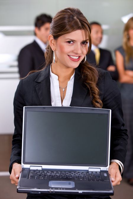 business woman with a laptop in an office smiling