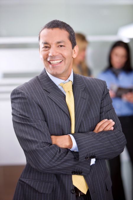 business man portrait in an office smiling