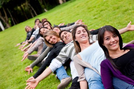 happy group of friends smiling outdoors in a park