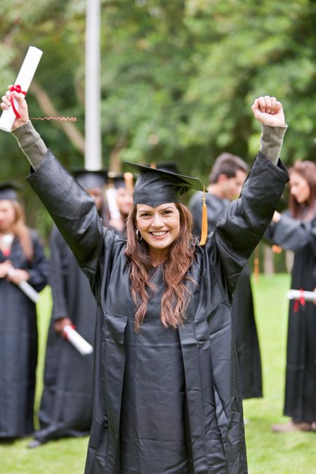 Excited grad student with her arms up