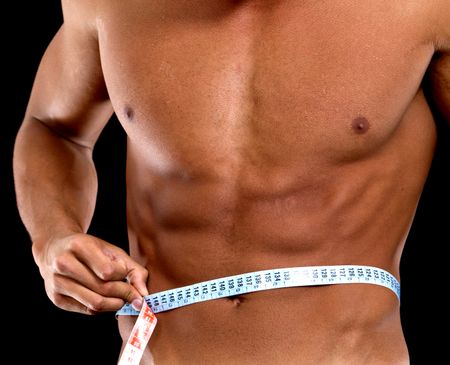 man with a muscular body measuring his abs - lose weight series