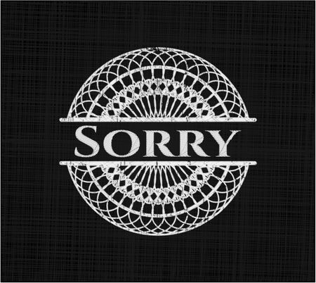 Sorry chalkboard emblem on black board